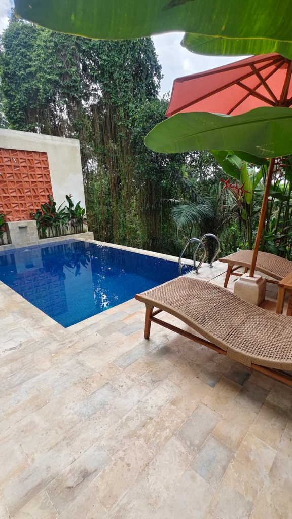 Serene poolside with lush greenery.